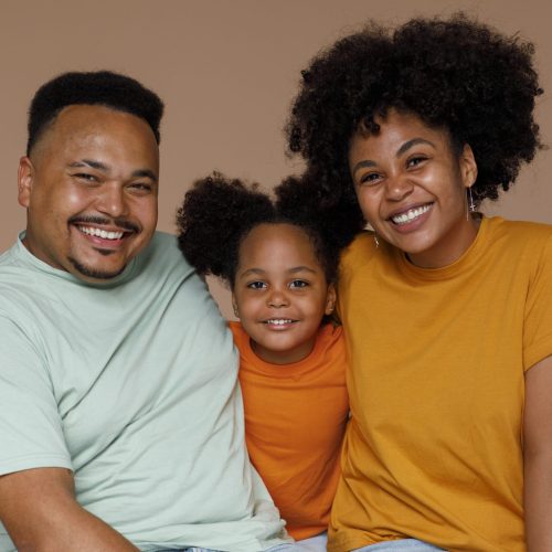 front-view-black-family-posing-studio